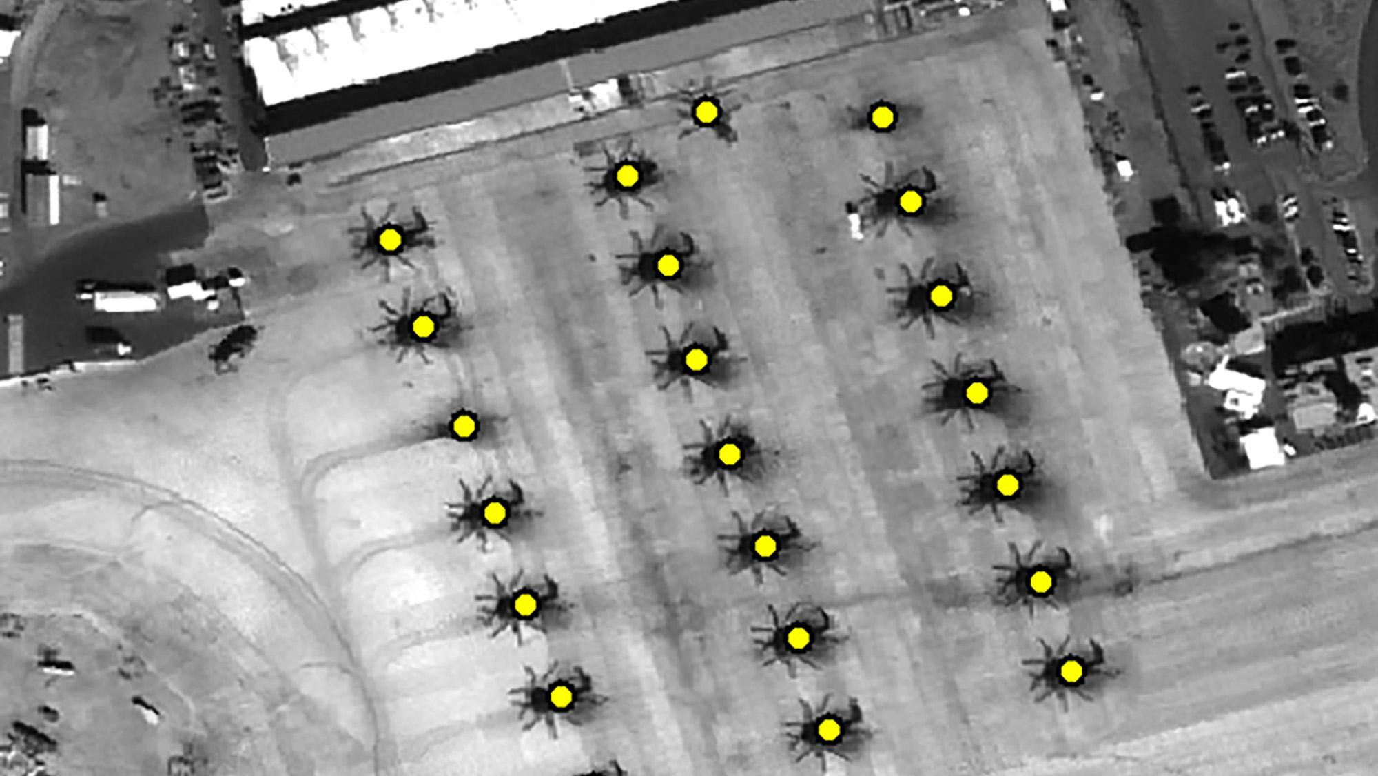Feature Analyst overhead capture of helicopters, helicopters are visually marked and identified, part of imagery analysis and mission support
